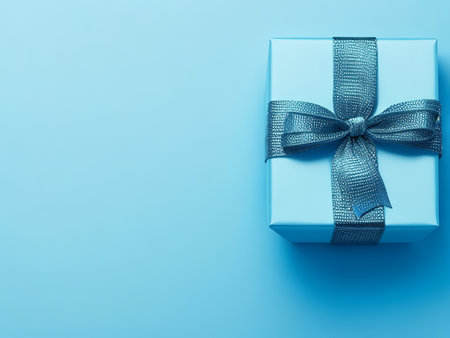 Unveil the Beauty of a Blue Satin Ribbon and Bow on a Vibrant Blue Background. Generative AI.の素材