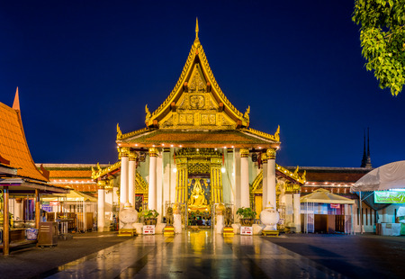 golden sculpture of the Buddha  in Buddhist temple at  twilight sceneの写真素材