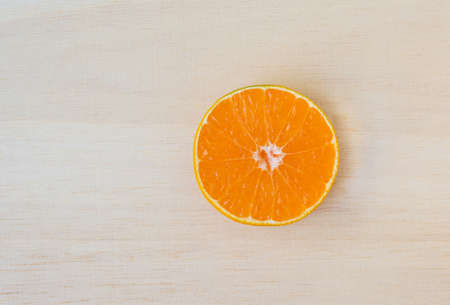 Fresh organic oranges halves fruits on  wooden backgroundの写真素材