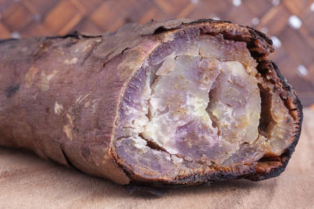 Grilled sweet potatoes on wood board and wooden backgroundの写真素材