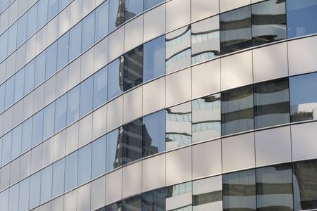 Buildings reflected in windows of modern office building