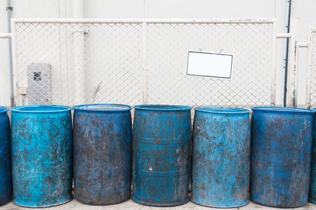 Blue plastic containers in a row for separate garbage collection.