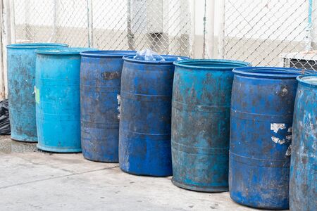 Blue plastic containers in a row for separate garbage collection.の写真素材