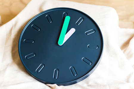 Close up shot of a clock with colorful hands.