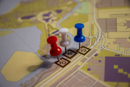 Colored pins on layout plan of a streetの写真素材