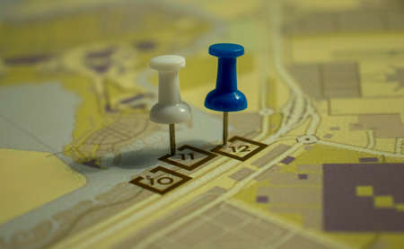 Colored pins on layout plan of a streetの写真素材