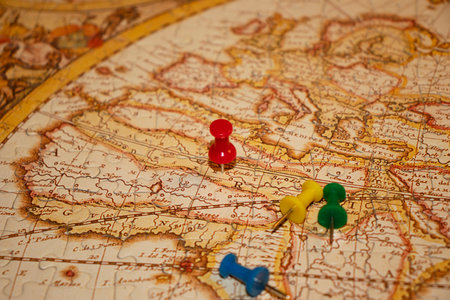 Colored pins on vintage jigsaw puzzle mapの写真素材