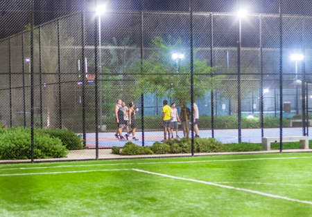 Dubai, UAE - 08.16.2022 - Youth on the basketball pitch at The pulse residence, Dubai Southの写真素材