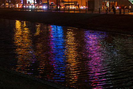 Colorful reflections of the city lights in the pondの写真素材