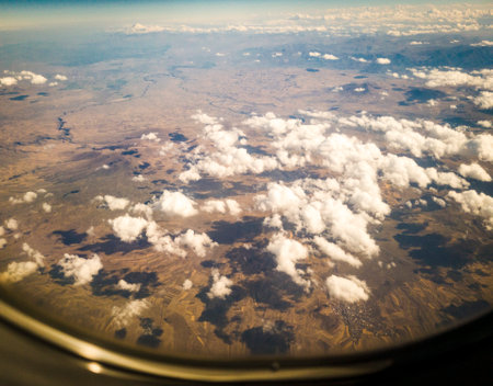 Shot of the clouds casting shadows on the land.の写真素材