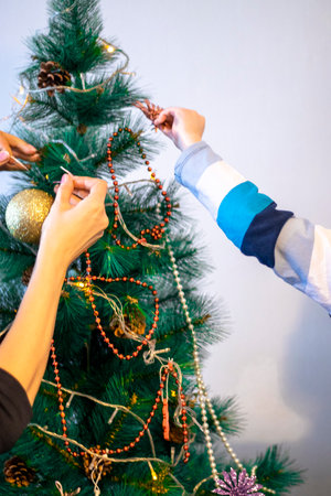 Close up shot of woman and little boy decorating christmas tree.の写真素材
