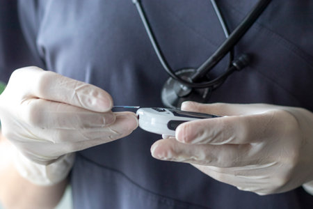 Close up shot of the nurse holding glucometer instrument