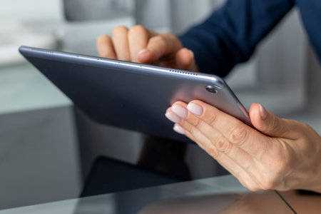 Close up shot of the woman with beautiful hands sitting in the meeting room during business meeting,...