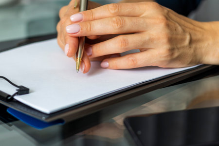 Close up shot of the woman with beautiful hands sitting in the meeting room during business meeting