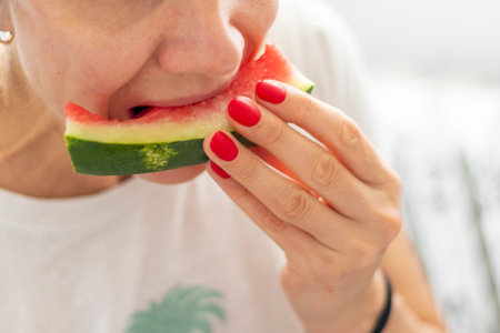 Shot of the woman eating watermelonの写真素材