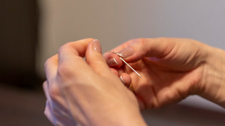 Shot of the woman with beautiful hands stitching.の写真素材