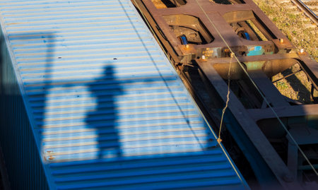Concept shot of the woman casting shadow down from the bridge to the train carrierの写真素材