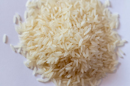 Close up shot of the uncooked white rice on the white backgroundの写真素材