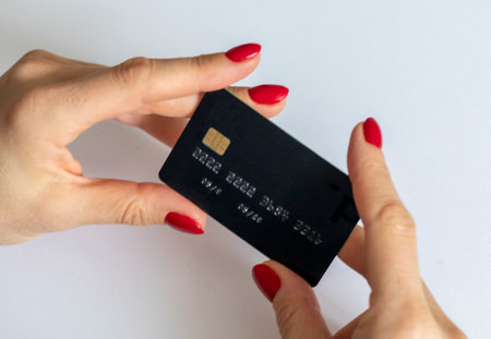 Shot of the woman holding black credit card.