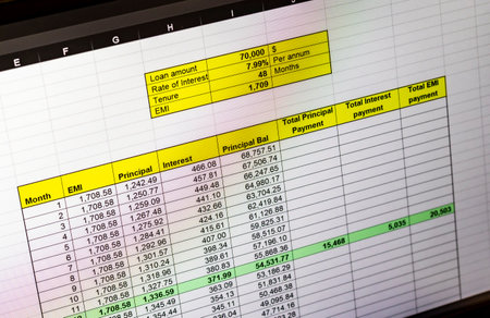 Shot of an dark mode excel sheet on computer screen showing bank loan amortization table.