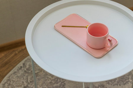 Coffee table with the pink cup for ladies on it. Conceptの写真素材