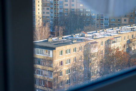 Typical eastern european city seen trough window at winterの写真素材