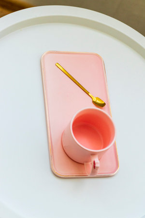 Coffee table with the pink cup for ladies on it.の写真素材