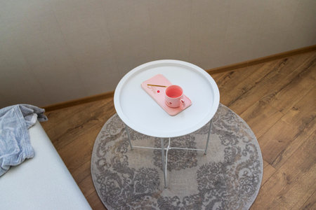 Coffee table with the pink cup for ladies on itの写真素材