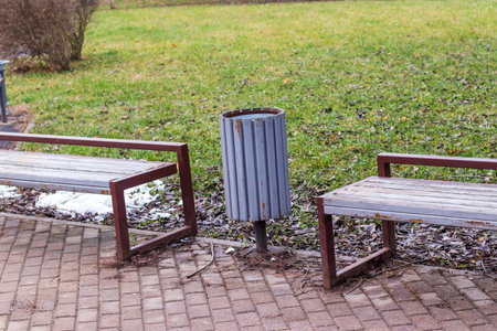 Shot of the trash bin by the benches in the parkの写真素材
