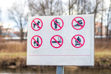 Close up shot of the information board in the park with restriction iconsの写真素材