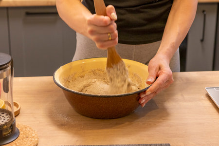 Hands mixing dough in a bowl