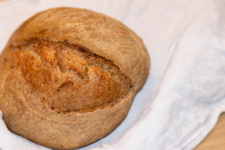 Shot of the freshly baked loaf of home made rye bread on the linen cloth.の写真素材