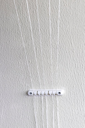 String from the cloth dryer fixture on the wallの写真素材