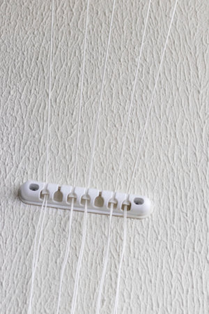 String from the cloth dryer fixture on the wallの写真素材