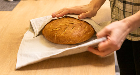 Shot of the freshly baked loaf of home made rye bread on the linen clothの写真素材