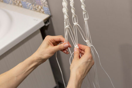 Woman weaving macrame flowerpot.の写真素材