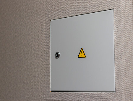 Close up shot of the door to the electric switchboard in the wall of the apartmentの写真素材