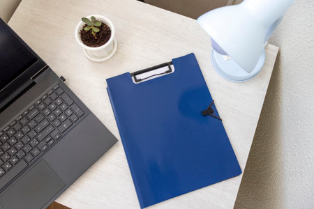 Shot of the plastic folder on the office desk with other office items.の写真素材