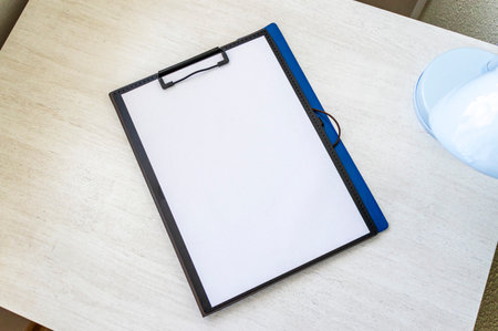 Shot of the plastic folder on the office desk with paper clip holder on the top. A4 size paper mock upの写真素材