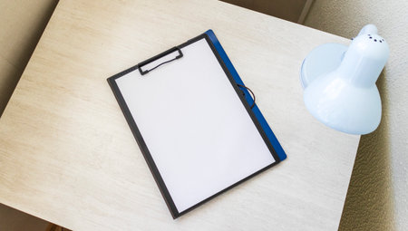 Shot of the plastic folder on the office desk with paper clip holder on the top. A4 size paper mock upの写真素材