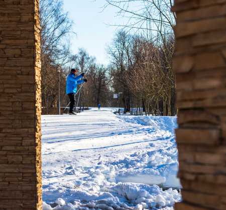 People enjoying skiing outdoors on sunny but cold weather.の写真素材
