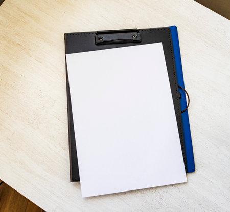 Shot of the plastic folder on the office desk with paper clip holder on the top. A4 size paper mock upの写真素材