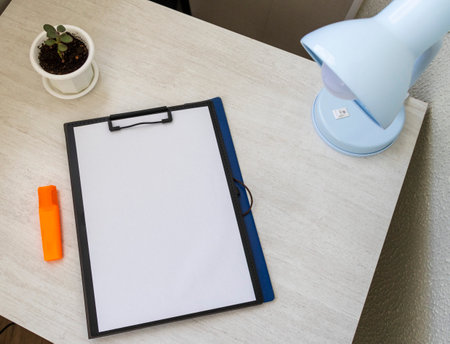Shot of the plastic folder on the office desk with paper clip holder on the top. A4 size paper mock upの写真素材