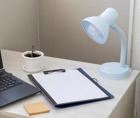 Shot of the plastic folder on the office desk with paper clip holder on the top and other office items. A4 size paper mock up.の写真素材