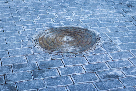 Manhole and interlock bricks with frost on them.の写真素材