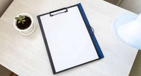 Shot of the plastic folder on the office desk with paper clip holder on the top. A4 size paper mock upの写真素材
