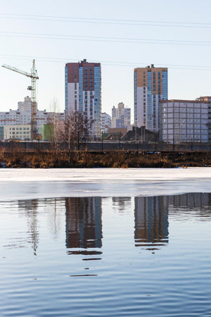 Frozen pond with urban backgroundの写真素材