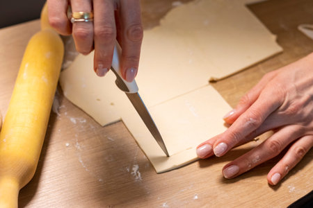 A woman cuts puff pastryの写真素材