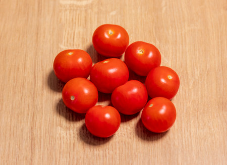 Cherry tomatoes on the wooden surfaceの写真素材