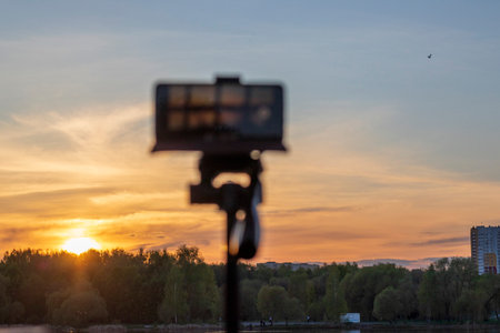 Cell phone on the tripod capturing sun set momentの写真素材